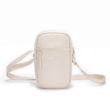 Zeeksack Travel Pouch (zandbeige) – schouderband en voorvak met rits.