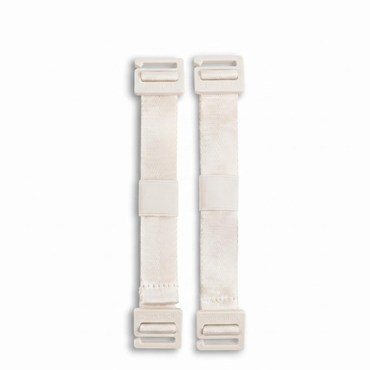 Twee Zeeksack Activity Straps i Sand White tegen een witte achtergrond