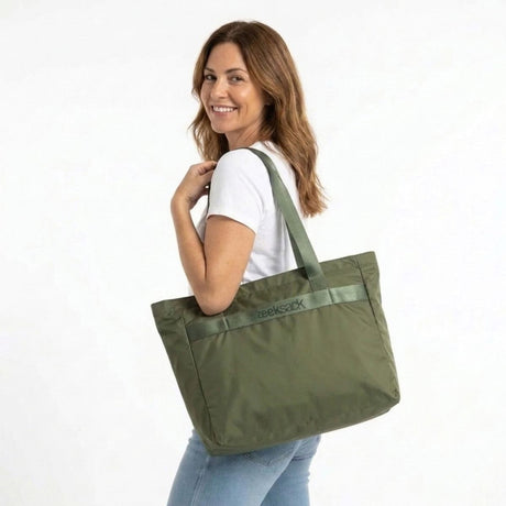 Vrouw draagt de Zeeksack Packable Travel Tote in Ranger Green over haar schouder